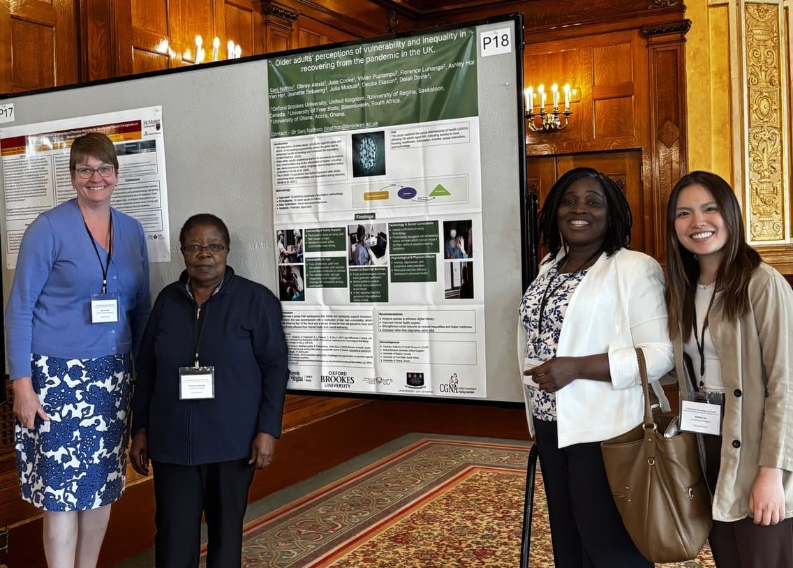 Research team standing beside an older adults research poster